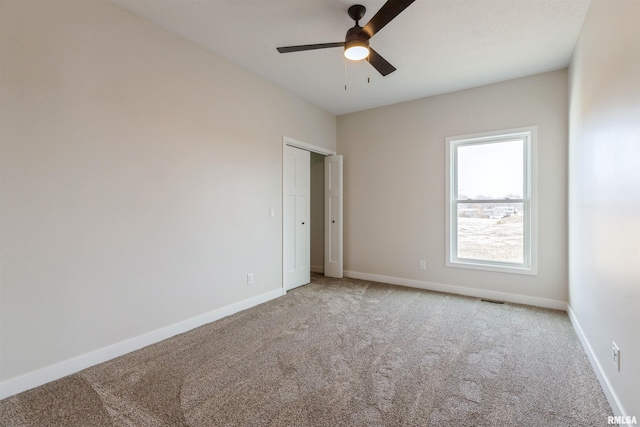 4613 W 12th St, Davenport, IA 52804 - empty room featuring light carpet, ceiling fan, and baseboards