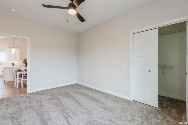 4613 W 12th St, Davenport, IA 52804 - unfurnished bedroom featuring carpet flooring, a closet, baseboards, and a ceiling fan
