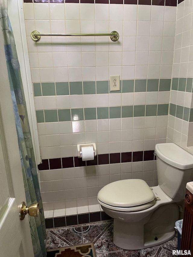 bathroom featuring tile walls, toilet, tile patterned floors, and vanity