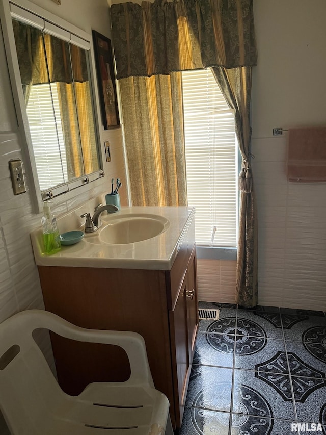 bathroom with tile walls and vanity