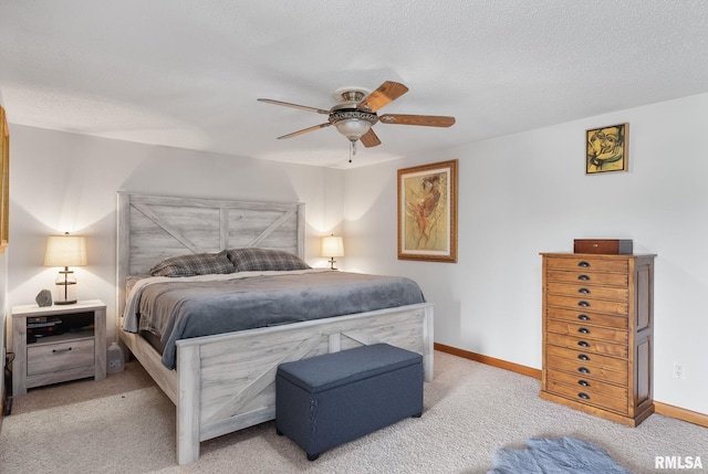 bedroom featuring a textured ceiling, ceiling fan, light colored carpet, and baseboards