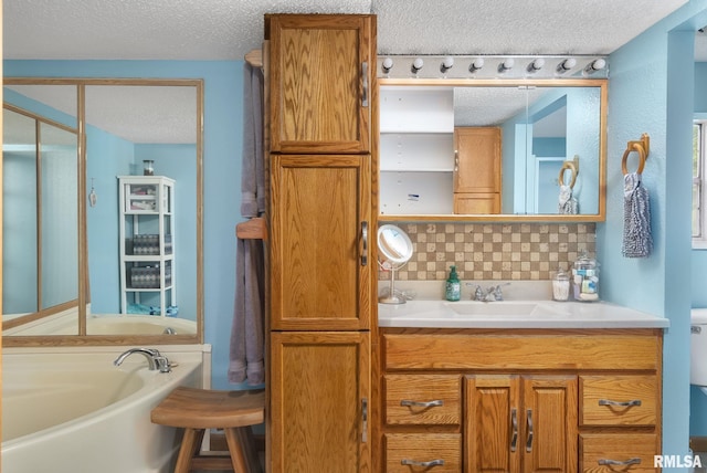 full bath with tasteful backsplash, a textured ceiling, vanity, and a bath