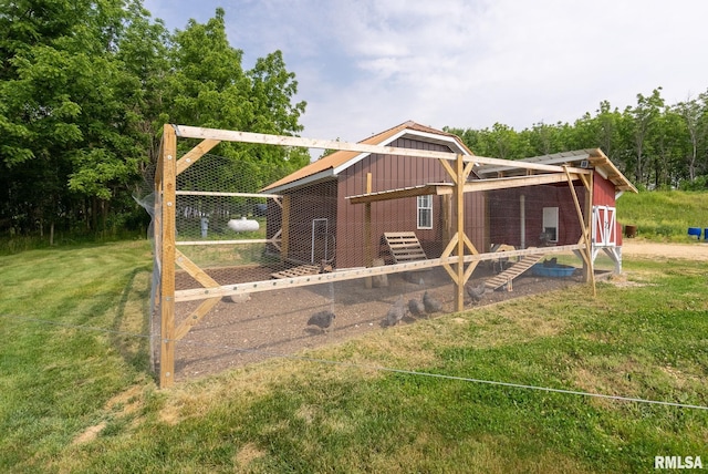 view of front of house with an outbuilding, board and batten siding, and exterior structure