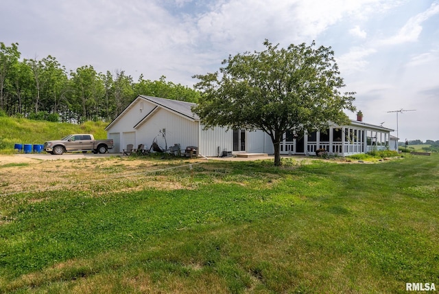 exterior space with a lawn and an attached garage