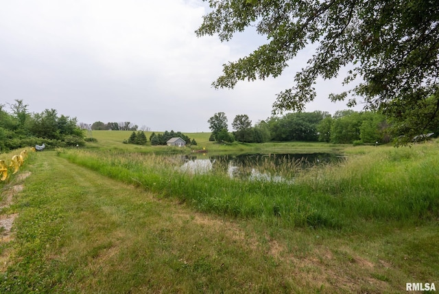 view of landscape featuring a water view and a rural view