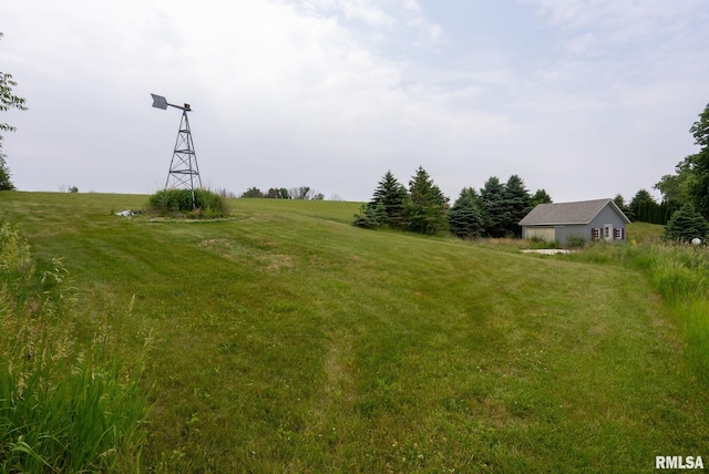 view of yard with a rural view, an outdoor structure, and a barn