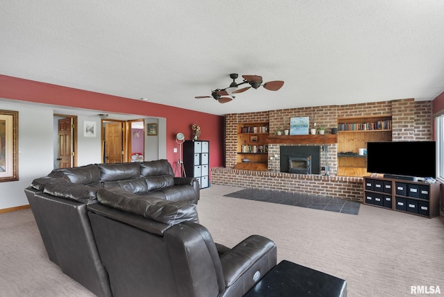 living area featuring carpet floors, a textured ceiling, baseboards, and a ceiling fan