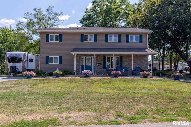 view of front of property featuring a front lawn and a porch