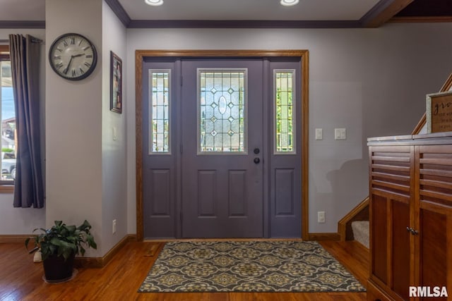 entryway featuring hardwood / wood-style floors and crown molding