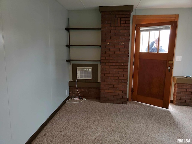 unfurnished living room with a wall mounted air conditioner, brick wall, and carpet flooring