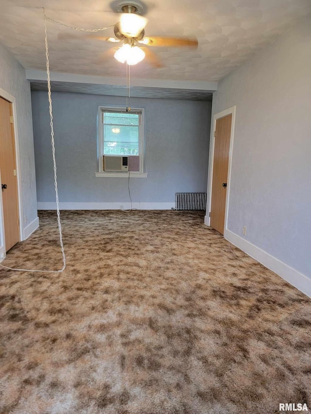 unfurnished bedroom featuring radiator, cooling unit, baseboards, carpet floors, and ceiling fan