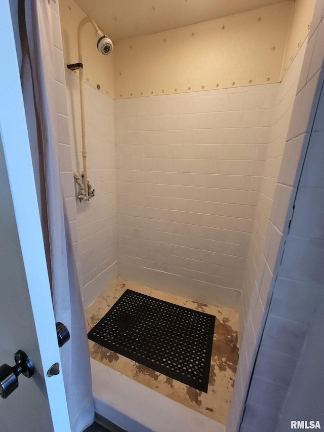 full bathroom with a tile shower