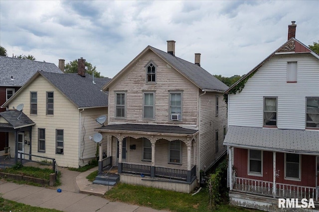 view of front of property featuring cooling unit and a porch