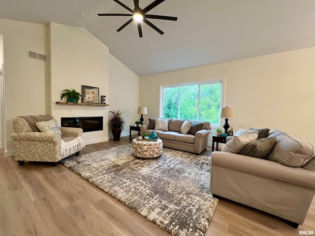 living room featuring high vaulted ceiling, hardwood / wood-style flooring, and ceiling fan