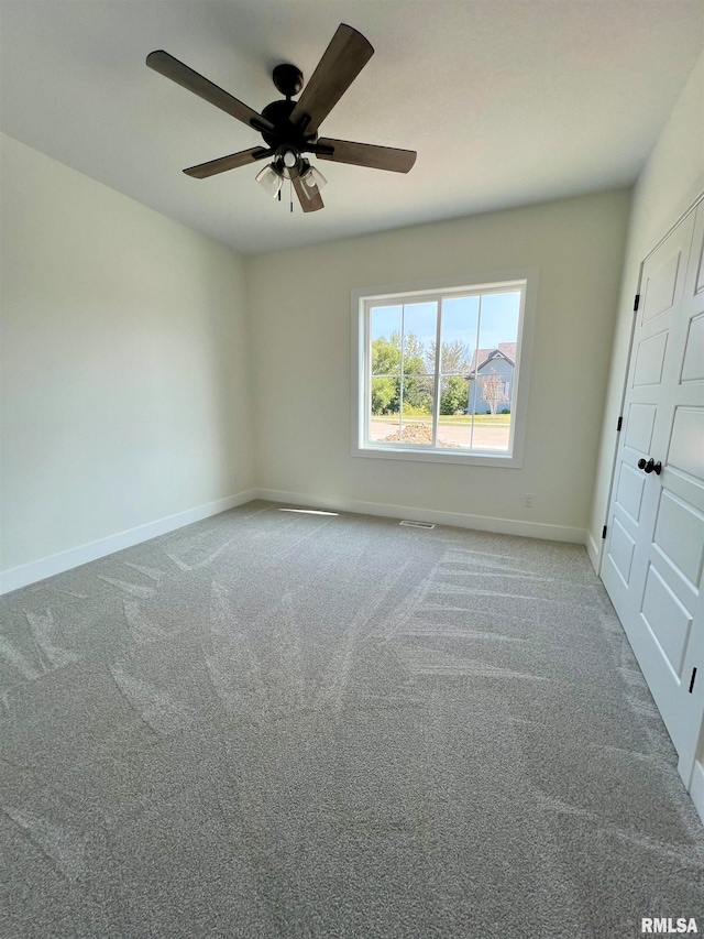 carpeted empty room with ceiling fan