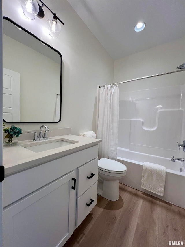 full bathroom with toilet, vanity, shower / bath combo with shower curtain, and hardwood / wood-style floors