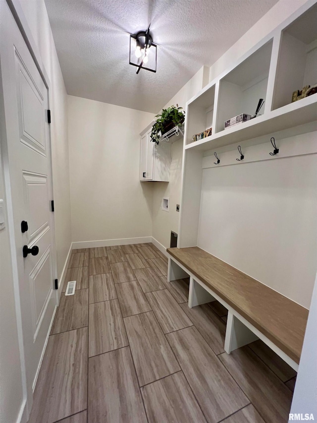 mudroom with a textured ceiling