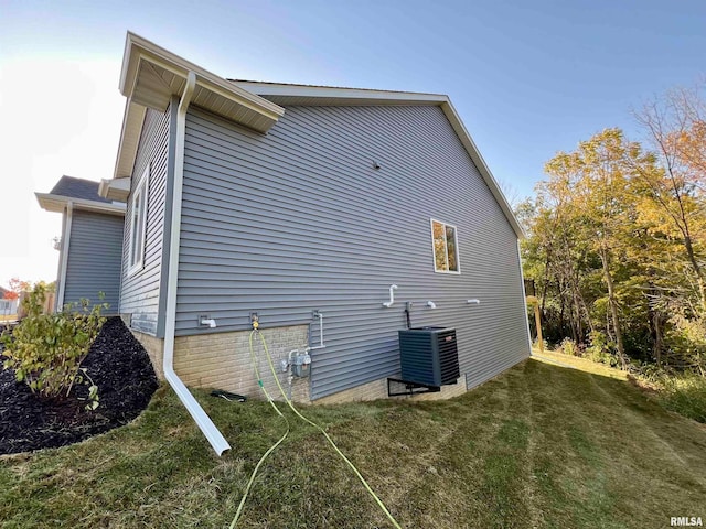 view of property exterior featuring a yard and central AC