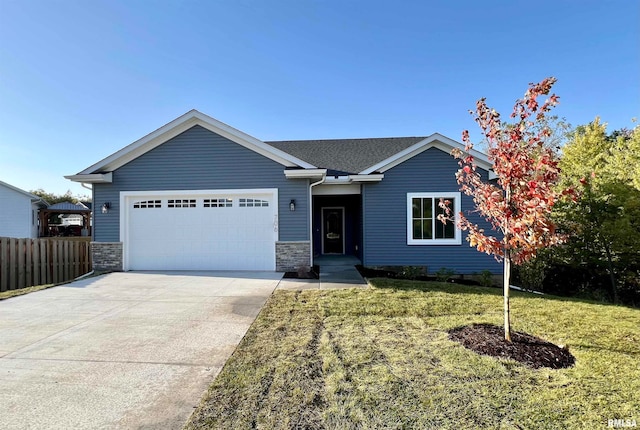 view of front of property with a garage and a front yard