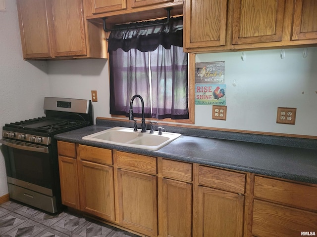 kitchen with sink, light tile patterned floors, and gas stove