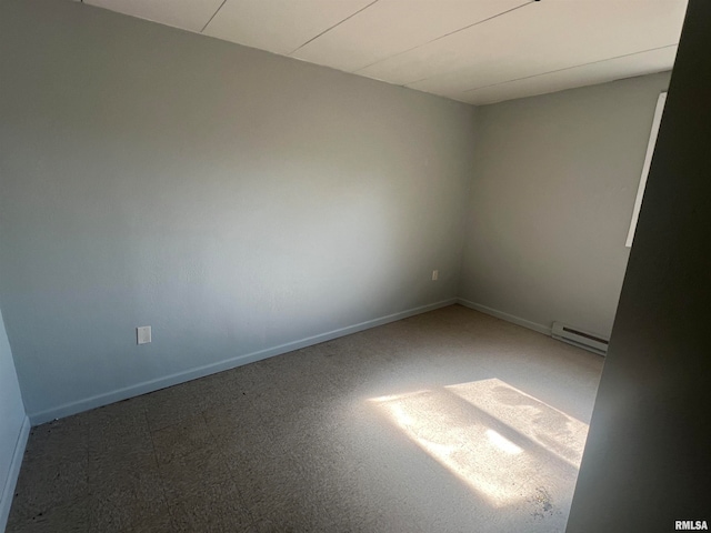 spare room featuring carpet floors and a baseboard radiator