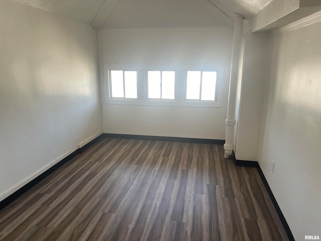 unfurnished room featuring a textured ceiling and dark wood-type flooring