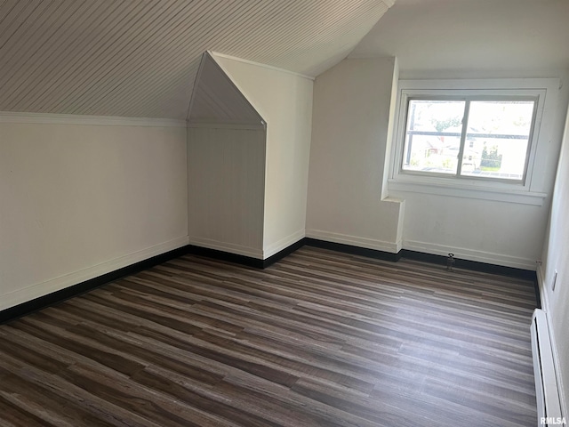 bonus room with a baseboard radiator, dark hardwood / wood-style floors, and lofted ceiling