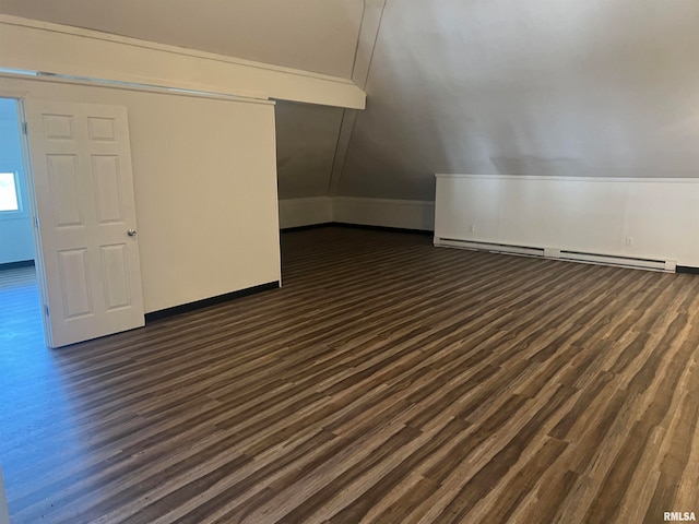 bonus room featuring vaulted ceiling, baseboard heating, and dark hardwood / wood-style flooring