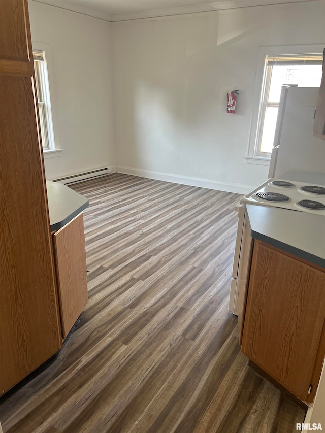 kitchen with white electric stovetop, a baseboard heating unit, and dark wood-type flooring