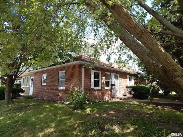 view of property exterior with a lawn