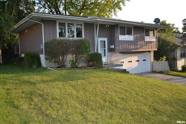 raised ranch with a front yard and a garage