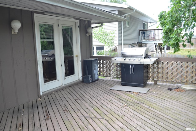 wooden terrace with french doors and area for grilling