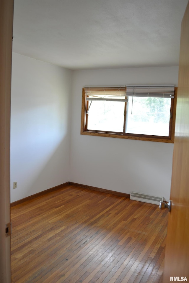 empty room featuring hardwood / wood-style floors