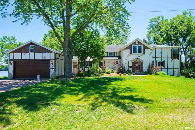 view of front of home featuring a garage and a front lawn