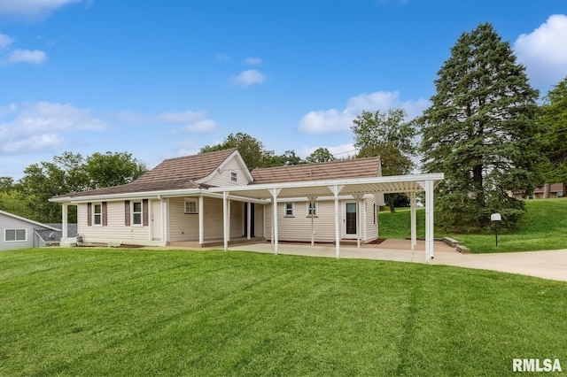 rear view of house with a lawn and a patio area