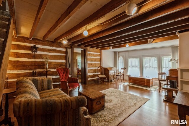 interior space featuring beam ceiling and hardwood / wood-style floors