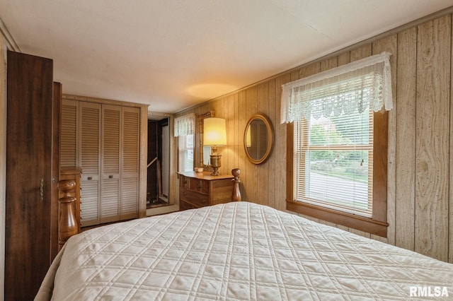 unfurnished bedroom featuring a closet and wood walls