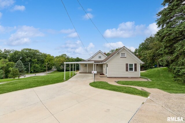 bungalow featuring a front yard and a carport