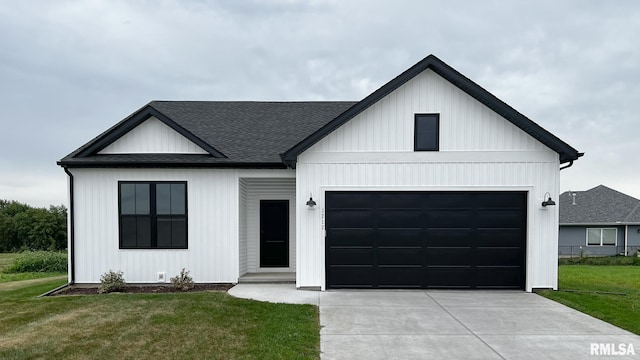 modern farmhouse featuring a front yard and a garage