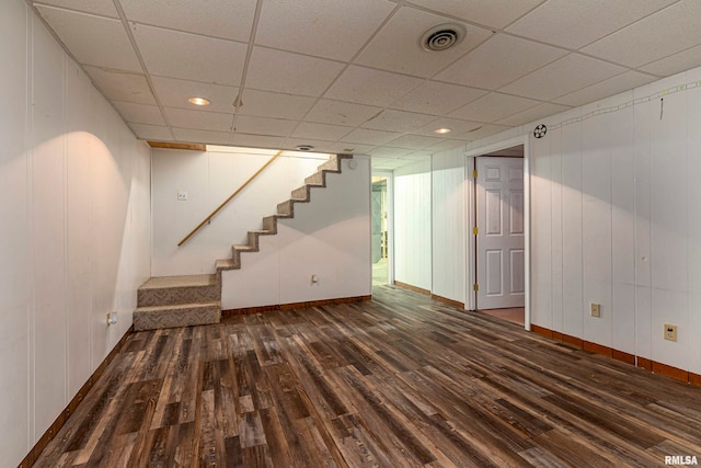 basement with dark wood-type flooring and a drop ceiling