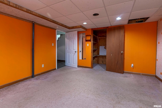 unfurnished room featuring carpet floors and a paneled ceiling