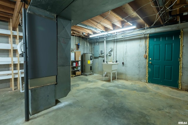 basement featuring sink, water heater, and electric panel