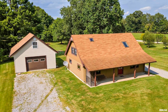 exterior space featuring an outbuilding, a garage, and a front yard