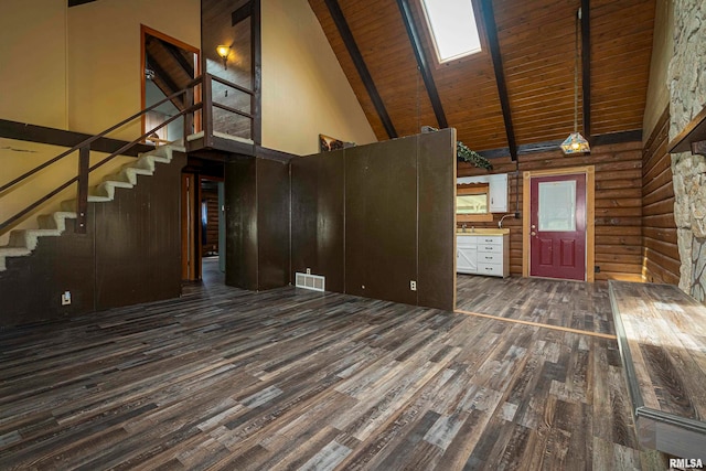 unfurnished living room featuring high vaulted ceiling, beamed ceiling, hardwood / wood-style floors, and wooden ceiling