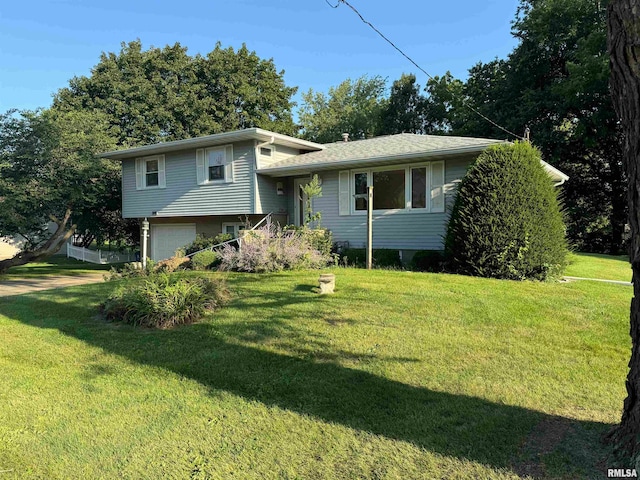 tri-level home with a front yard and a garage