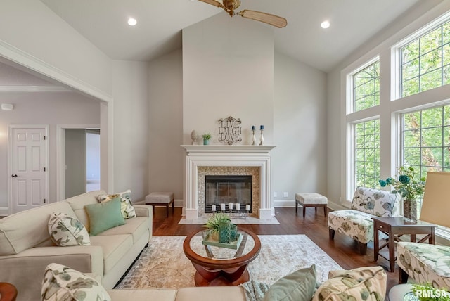 living room featuring ceiling fan, dark hardwood / wood-style floors, and high vaulted ceiling