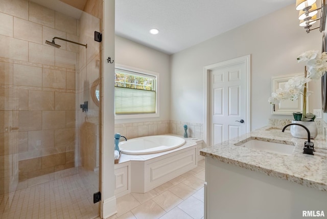 bathroom with tile patterned flooring, shower with separate bathtub, and vanity