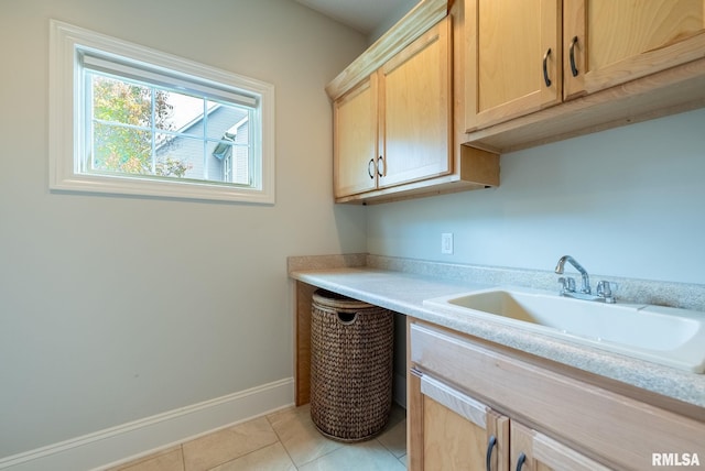 interior space with light tile patterned floors and sink