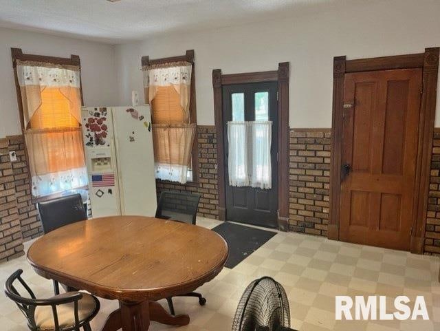 dining room with brick wall