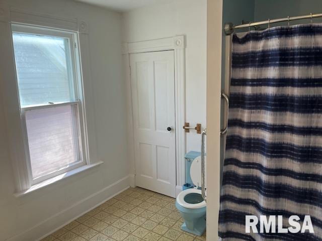 bathroom with tile patterned floors and toilet